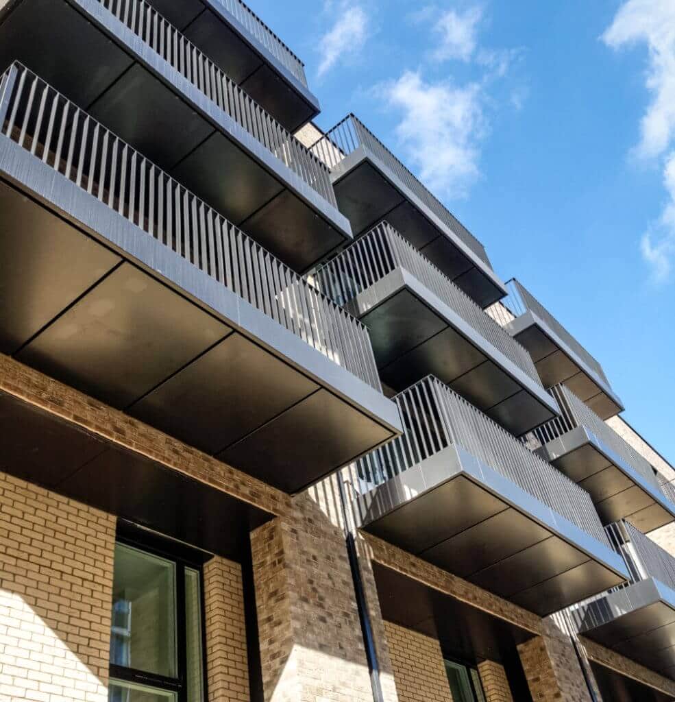 Exterior of the flats shows a modern finish with clean brickwork and sparkling metal balcony balustrades
