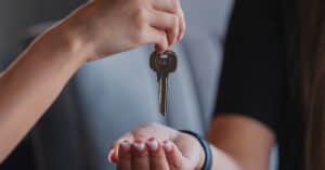 Hands exchanging a key