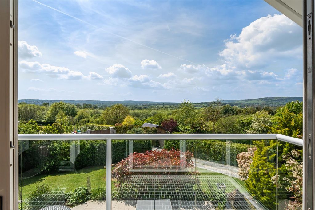 A photo is taken overlooking a balcony to show exquisite views across the Kent countryside