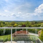 A photo is taken overlooking a balcony to show exquisite views across the Kent countryside