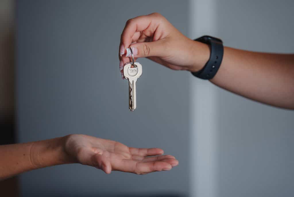 One person passing a house key to another.
