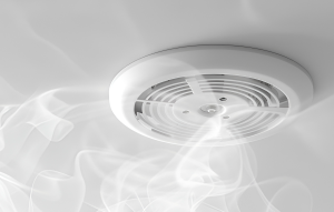Photo shows a smoke alarm and smoke