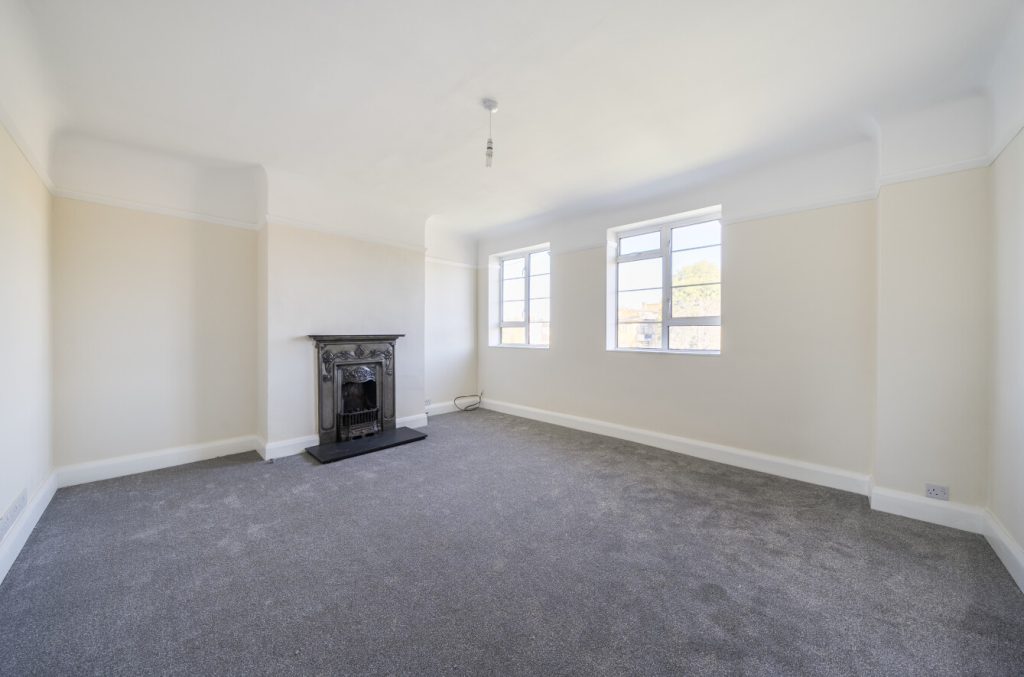 Another view of the reception room shows large windows and the fireplace.