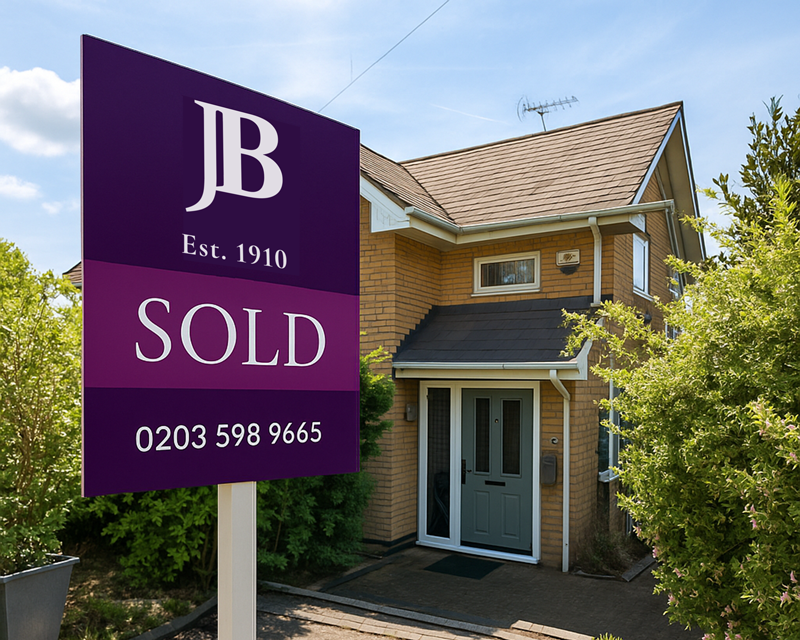 A sold slip covers a for sale board outside a Shooter's Hill property